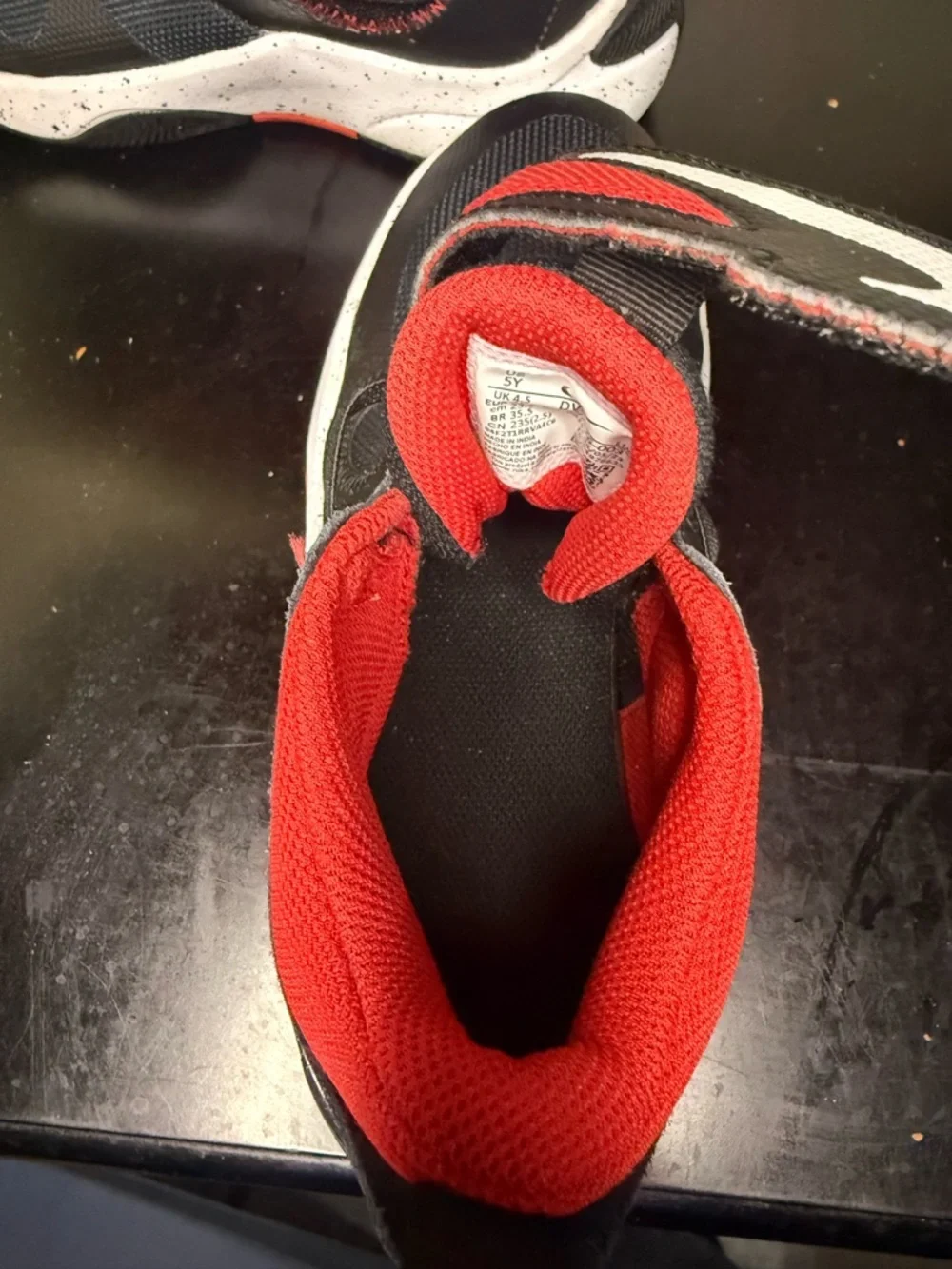 Nike Kids Black and Red Athletic Sneakers with White Speckled Midsole